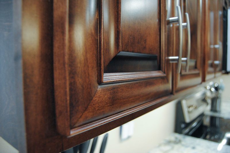 Close-up of a stained raised-panel cabinet door