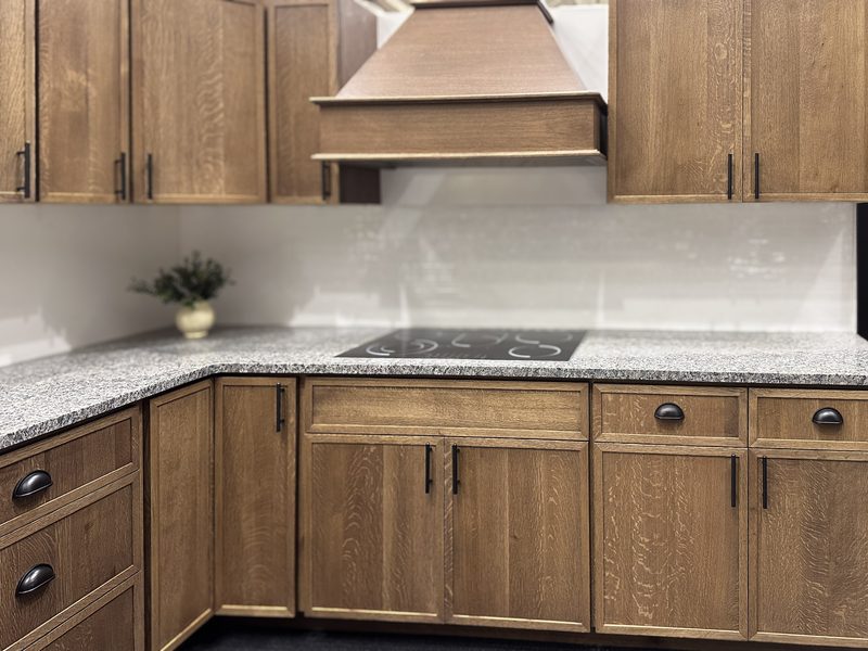 A kitchen in quartersawn oak cabinetry with a matching range hood